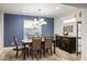 Stylish dining room with blue accent wall, modern chandelier, and elegant furniture on a patterned rug at 51 Morning Mimosa Ct, Henderson, NV 89012