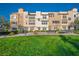 Charming townhome complex with manicured lawn and inviting benches for residents to enjoy the communal spaces at 51 Morning Mimosa Ct, Henderson, NV 89012