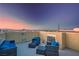 Relaxing rooftop patio with comfortable seating, views of mountains, and colorful sunrise at 51 Morning Mimosa Ct, Henderson, NV 89012