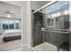 Modern shower with glass door and stone-style walls, conveniently located near the bedroom at 51 Morning Mimosa Ct, Henderson, NV 89012