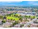A scenic aerial view capturing a neighborhood with mountains in the background, lush greenery and homes at 5112 Foggia Ave, Las Vegas, NV 89130