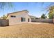 This backyard features a low maintenance design with gravel and a brick patio at 5112 Foggia Ave, Las Vegas, NV 89130