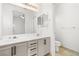 Bright bathroom featuring a double sink vanity and a large mirror with modern lighting at 5112 Foggia Ave, Las Vegas, NV 89130