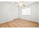 A clean bedroom with wood floor, ceiling fan, closet and bright window at 5112 Foggia Ave, Las Vegas, NV 89130