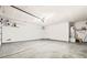 Clean, empty garage with water heater, overhead lighting and ample space for storage at 5112 Foggia Ave, Las Vegas, NV 89130