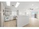 Well-lit kitchen with a breakfast bar, white appliances, and modern finishes at 5112 Foggia Ave, Las Vegas, NV 89130