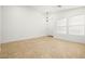 Spacious living room showcasing tile flooring, neutral walls, and natural light from the windows at 5112 Foggia Ave, Las Vegas, NV 89130