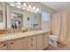 Bright bathroom features a double sink vanity with granite countertops, and a shower-tub combo at 5196 Mandalay Springs Dr # 101, Las Vegas, NV 89120