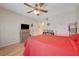 Spacious bedroom with wood-look floors, flat screen tv, and lots of natural light at 5196 Mandalay Springs Dr # 101, Las Vegas, NV 89120