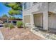 Condo exterior featuring desert landscaping, walkway, and a covered parking area in background at 5196 Mandalay Springs Dr # 101, Las Vegas, NV 89120