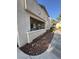 Exterior view of a well-maintained home with a covered patio and desert landscaping at 5196 Mandalay Springs Dr # 101, Las Vegas, NV 89120