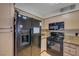 Cozy kitchen features a black refrigerator and gas range with plenty of cabinet space at 5196 Mandalay Springs Dr # 101, Las Vegas, NV 89120