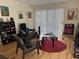 Inviting living room with wood floors, comfortable seating, and bright natural light from sliding glass doors at 5196 Mandalay Springs Dr # 101, Las Vegas, NV 89120