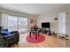 Open concept living room with hardwood floors, sliding glass door, and neutral color palette at 5196 Mandalay Springs Dr # 101, Las Vegas, NV 89120