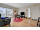 Living room with light wood floors, sliding glass door, and simple furnishings at 5196 Mandalay Springs Dr # 101, Las Vegas, NV 89120