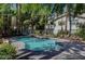 Inviting community pool surrounded by comfortable lounge chairs and verdant foliage at 5196 Mandalay Springs Dr # 101, Las Vegas, NV 89120