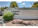 Community sign for Canyon Willow featuring mature landscaping and unique rock features at 5196 Mandalay Springs Dr # 101, Las Vegas, NV 89120