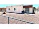 Modest single-story home featuring a fenced gravel front yard, light stucco walls, and a small covered patio at 5305 W Cheyenne Ave, Las Vegas, NV 89108