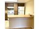 Compact kitchen featuring wood cabinets and a breakfast bar for easy meal prep and casual dining at 5305 W Cheyenne Ave, Las Vegas, NV 89108