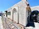 Side view of home featuring an arched doorway and an exterior wall constructed from light stucco material at 5305 W Cheyenne Ave, Las Vegas, NV 89108