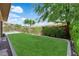 Lush backyard with green lawn, mature trees, and view of a swimming pool in the distance at 5542 Oak Bend Dr, Las Vegas, NV 89135
