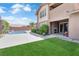 Beautiful backyard with manicured lawn, swimming pool, and covered patio area for outdoor entertaining at 5542 Oak Bend Dr, Las Vegas, NV 89135