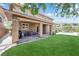 This backyard boasts a covered patio, green lawn, and a refreshing pool, perfect for outdoor relaxation and entertaining at 5542 Oak Bend Dr, Las Vegas, NV 89135