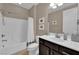 Bright bathroom featuring a white shower-tub combination and dark vanity at 5542 Oak Bend Dr, Las Vegas, NV 89135