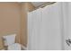 Bathroom with a white toilet and a white shower curtain rod and white curtain at 5542 Oak Bend Dr, Las Vegas, NV 89135