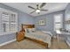 Bedroom with a queen bed, ceiling fan, and shuttered windows at 5542 Oak Bend Dr, Las Vegas, NV 89135