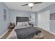 Well-lit bedroom featuring neutral carpet, ceiling fan, and shuttered windows at 5542 Oak Bend Dr, Las Vegas, NV 89135