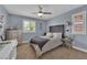 Cozy bedroom with a ceiling fan, light blue walls, and shuttered windows at 5542 Oak Bend Dr, Las Vegas, NV 89135