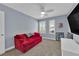 Bedroom with a red sofa and ceiling fan at 5542 Oak Bend Dr, Las Vegas, NV 89135