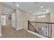 Bright hallway featuring an ornate chandelier and staircase with neutral colored walls at 5542 Oak Bend Dr, Las Vegas, NV 89135
