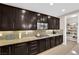 Kitchen with extensive counterspace, lots of dark cabinets, and stainless microwave at 5542 Oak Bend Dr, Las Vegas, NV 89135