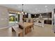Eat-in kitchen with dark cabinets, stainless steel appliances, and sliding glass doors to a backyard patio at 5542 Oak Bend Dr, Las Vegas, NV 89135