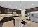 Well-lit kitchen features a granite island, stainless steel appliances, and plenty of cabinet space at 5542 Oak Bend Dr, Las Vegas, NV 89135