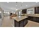 Kitchen with granite counters, island, and stainless appliances that opens to the dining and living area at 5542 Oak Bend Dr, Las Vegas, NV 89135