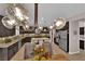 Spacious kitchen features granite countertops, stainless steel appliances, and stylish lighting fixtures at 5542 Oak Bend Dr, Las Vegas, NV 89135