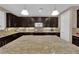 Bright kitchen with granite island and stainless appliances offer a functional and modern space at 5542 Oak Bend Dr, Las Vegas, NV 89135