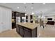 Open kitchen layout features island with granite countertop and stainless appliances at 5542 Oak Bend Dr, Las Vegas, NV 89135
