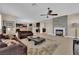 Spacious living room with an adjacent kitchen, fireplace, tile flooring, and an open layout for modern living at 5542 Oak Bend Dr, Las Vegas, NV 89135