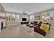 Comfortable living room featuring a fireplace, large windows with plantation shutters and neutral decor at 5542 Oak Bend Dr, Las Vegas, NV 89135