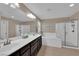 Dual sink bathroom with shower and a large soaking tub at 5542 Oak Bend Dr, Las Vegas, NV 89135