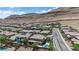 Aerial view of a well-planned community, showcasing uniform housing, lush landscaping, and the natural beauty of the surrounding desert hills at 5542 Oak Bend Dr, Las Vegas, NV 89135