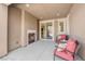 Covered patio features fireplace, seating, and sliding door to the home's interior at 5542 Oak Bend Dr, Las Vegas, NV 89135