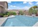 This beautiful backyard features a serene swimming pool with decorative water features and desert landscaping at 5542 Oak Bend Dr, Las Vegas, NV 89135