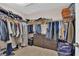 Walk-in closet with hanging clothes and storage drawers at 5542 Oak Bend Dr, Las Vegas, NV 89135