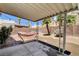 Cozy backyard featuring a hammock, patio, desert landscaping, and block wall at 6058 Grape Blossom Ave, Las Vegas, NV 89142
