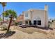 The backyard features a hammock and patio area, with mature palm trees at 6058 Grape Blossom Ave, Las Vegas, NV 89142